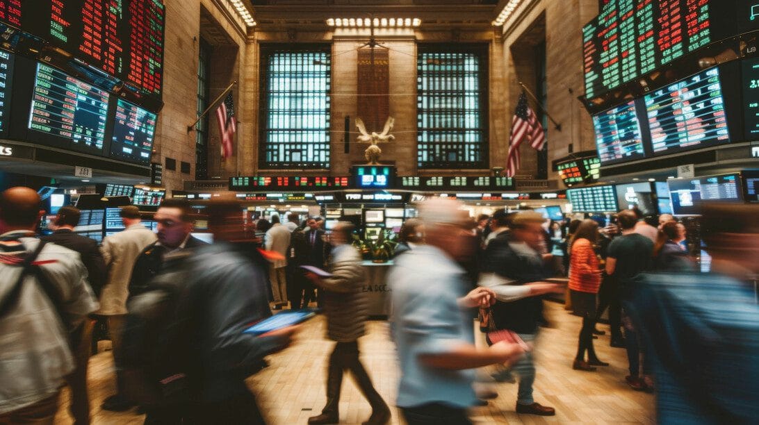 Blurred motion of traders and investors on a bustling stock exchange trading floor with numerous digital displays - Hispamer Noticias Hispamer Noticias