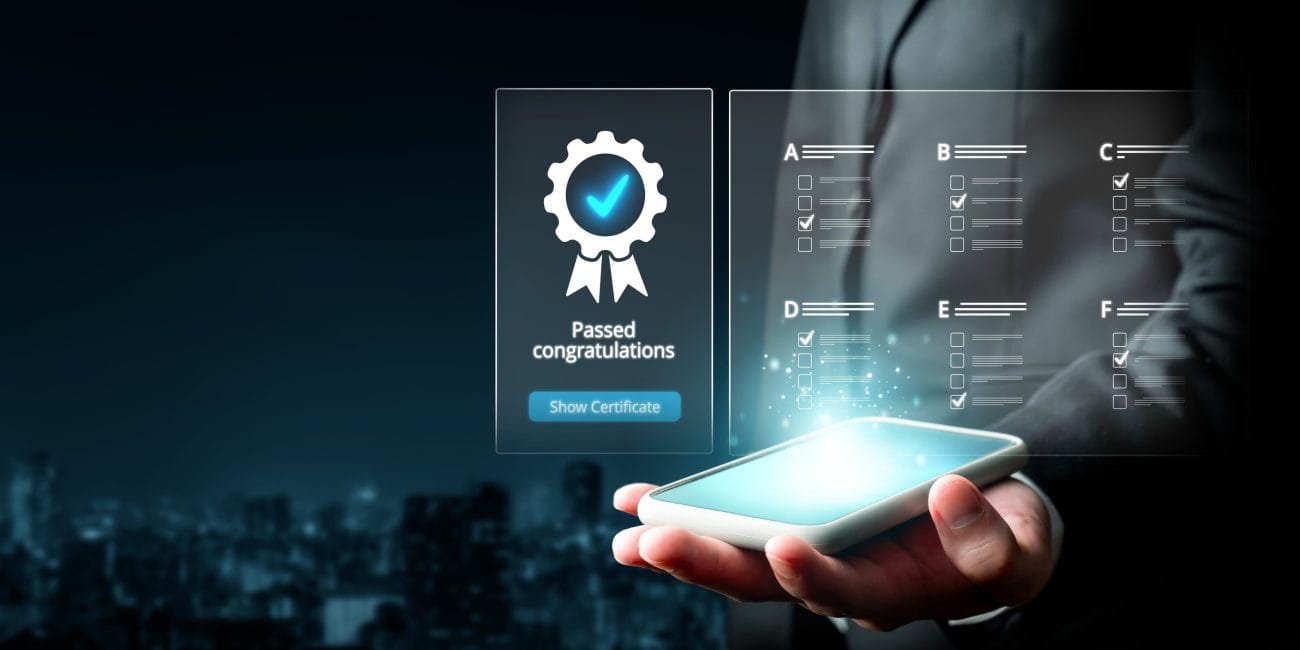 Hand holding a smartphone with holographic certification and checklist visuals above it, symbolizing digital completion.&nbsp;Hispamer Noticias