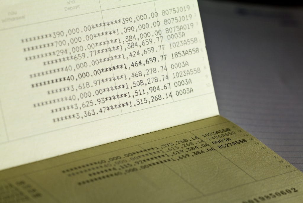 Close-up of a bank statement page filled with rows of numeric figures and asterisks, like a financial ledger above a darker surface.&nbsp;Hispamer Noticias