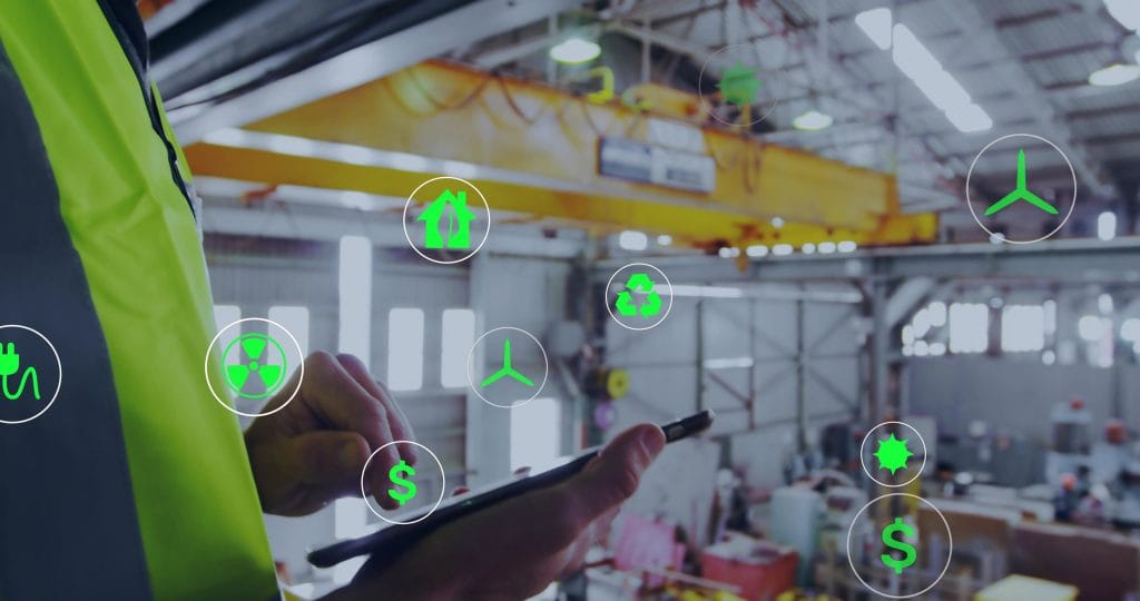 Factory worker uses a tablet with green icons (energy, recycling, safety, costs) to convey monitoring of sustainable operations.&nbsp;Hispamer Noticias
