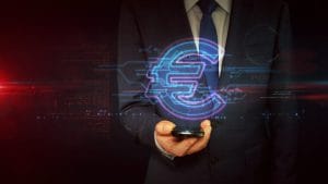 Businessperson in a suit holding a smartphone with a glowing holographic euro symbol and digital circuitry. Fintech concept.&nbsp;Hispamer Noticias